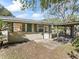 Backyard view of the home featuring an exterior door, window, and attached carport at 2605 Ne 14Th Ave, Ocala, FL 34470