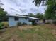 View of home's backyard, showcasing a covered patio and mature trees for relaxing outdoor living at 2605 Ne 14Th Ave, Ocala, FL 34470