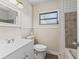 Bathroom featuring neutral tile accents, modern vanity and window at 2605 Ne 14Th Ave, Ocala, FL 34470