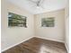 Bedroom featuring two large windows that provide ample natural light and wood-look flooring at 2605 Ne 14Th Ave, Ocala, FL 34470