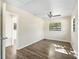 Sunlit bedroom with wood-look flooring, a ceiling fan, and bright natural light at 2605 Ne 14Th Ave, Ocala, FL 34470