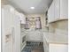 Clean kitchen with white appliances, marble countertops and sink with natural light at 2605 Ne 14Th Ave, Ocala, FL 34470