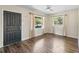 Bright room with wood floors, neutral walls, a ceiling fan, and two windows at 2605 Ne 14Th Ave, Ocala, FL 34470