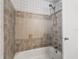Neutral tiled shower with tub and modern showerhead at 2605 Ne 14Th Ave, Ocala, FL 34470