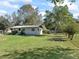 Well-maintained lawn surrounding a quaint home with a metal roof at 2605 Ne 14Th Ave, Ocala, FL 34470