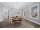 Elegant dining room with chandelier, hardwood floors, and large windows at 2704 Se 31St St, Ocala, FL 34471