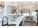 Bright kitchen with white cabinets, open shelving, and a farmhouse sink at 2704 Se 31St St, Ocala, FL 34471