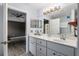 Double vanity bathroom with marble countertop, and access to bedroom at 35 Teak Rd, Ocala, FL 34472