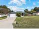 Single-story home with gray exterior, attached garage, and landscaping at 35 Teak Rd, Ocala, FL 34472