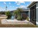 Landscaped front yard with palm trees and decorative plants at 35 Teak Rd, Ocala, FL 34472