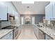 Modern kitchen with light blue cabinets and granite countertops at 35 Teak Rd, Ocala, FL 34472