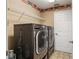 Laundry room with washer, dryer, and shelving at 35 Teak Rd, Ocala, FL 34472