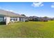 Large backyard with grassy area and homes beyond at 7066 Sw 91St Ct, Ocala, FL 34481