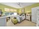 Bright bedroom with a large window, stylish furnishings and an ensuite bathroom at 7066 Sw 91St Ct, Ocala, FL 34481