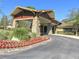 Clubhouse entrance showcases stone accents, porte-cochere, red flower beds, and well-maintained landscaping at 7066 Sw 91St Ct, Ocala, FL 34481