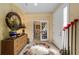 Elegant foyer features tile flooring, decorative mirror, and flows seamlessly into the rest of the home at 7066 Sw 91St Ct, Ocala, FL 34481