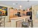 Charming kitchen with wood cabinets, black appliances, and a breakfast bar at 7066 Sw 91St Ct, Ocala, FL 34481