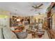 Open concept living room connected to the kitchen featuring ceiling fans and comfortable furniture at 7066 Sw 91St Ct, Ocala, FL 34481