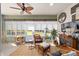 Inviting sunroom with stylish wicker furniture, ceiling fan, and view of the backyard at 7066 Sw 91St Ct, Ocala, FL 34481
