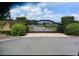 Gated entrance to a community with landscaping and a paved road at 7403 Ne 22Nd Court Rd, Ocala, FL 34479