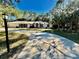A lovely one-story home with a winding driveway, lush landscaping, and an attached two-car garage at 7535 Sw 185 Avenue Rd, Dunnellon, FL 34432