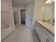 Bathroom featuring a bathtub, glass shower, double vanity, and tiled flooring at 8357 Sw 58Th Ave, Ocala, FL 34476