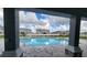 View of community pool framed by columns, showcasing a relaxing outdoor space at 8357 Sw 58Th Ave, Ocala, FL 34476