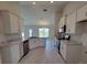 Well-lit open kitchen with white cabinets, stainless steel appliances, and granite countertops at 8357 Sw 58Th Ave, Ocala, FL 34476