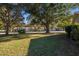 Community view showing homes with tree-lined streets and lush landscaping at 8625 Sw 94Th Ln # G, Ocala, FL 34481