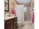 Clean bathroom featuring a tub, shower, and vanity with dark wood cabinets at 8625 Sw 94Th Ln # G, Ocala, FL 34481