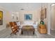 Living area with white couch and wicker coffee table; bright and airy at 8625 Sw 94Th Ln # G, Ocala, FL 34481