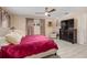 Spacious main bedroom with king bed, armchair, and large TV at 8625 Sw 94Th Ln # G, Ocala, FL 34481