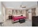 Large main bedroom with king-size bed, ceiling fan and en-suite bathroom at 8625 Sw 94Th Ln # G, Ocala, FL 34481