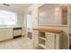 Kitchen features white cabinets, a wood-top island, and tile floor at 2444 Se 18Th Cir, Ocala, FL 34471