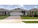 Charming single-story home featuring a manicured lawn, brick driveway, and a welcoming two-car garage at 4082 Nw 44Th Cir, Ocala, FL 34482