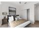 Cozy bedroom featuring a comfortable bed with neutral tones and a mirrored closet with adjacent entrance at 9350 Sw 91St Court Rd, Ocala, FL 34481