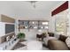 Comfortable living room featuring a large couch, floating shelves, and natural lighting at 9350 Sw 91St Court Rd, Ocala, FL 34481