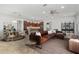Open-concept living area with a large leather sofa, dining area, and a view of the modern kitchen at 9350 Sw 91St Court Rd, Ocala, FL 34481