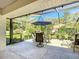 Enjoy this screened patio with an outdoor table and umbrella for sunny afternoons at 9805 Sw 190Th Terrace Rd, Dunnellon, FL 34432