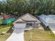 Aerial view of a single-story house with a well-maintained lawn at 10975 Sw 69Th Cir, Ocala, FL 34476