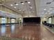 Expansive ballroom perfect for large events, featuring chandeliers and a stage at 10975 Sw 69Th Cir, Ocala, FL 34476