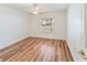 Bedroom with wood-look floors and window overlooking the backyard at 10975 Sw 69Th Cir, Ocala, FL 34476