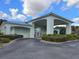 Palm Grove Club entrance with covered drop-off and meticulous landscaping at 10975 Sw 69Th Cir, Ocala, FL 34476