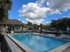 Community pool with ample seating, clear blue skies, and resort-style amenities at 10975 Sw 69Th Cir, Ocala, FL 34476