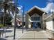 Community clubhouse entrance featuring a modern design, inviting outdoor seating and a beautifully landscaped walkway at 10975 Sw 69Th Cir, Ocala, FL 34476