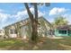 Back of the house, highlighting a large tree and spacious yard at 10975 Sw 69Th Cir, Ocala, FL 34476