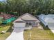 Charming single-story home boasts a well-manicured lawn, covered porch, and two-car garage, creating an inviting curb appeal at 10975 Sw 69Th Cir, Ocala, FL 34476