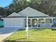 Charming single-story home featuring a well-maintained lawn and inviting front porch at 10975 Sw 69Th Cir, Ocala, FL 34476