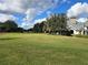 Landscaped putting green with homes in background at 10975 Sw 69Th Cir, Ocala, FL 34476