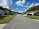 Quiet neighborhood street with well-maintained homes, green lawns, and clear blue skies at 10975 Sw 69Th Cir, Ocala, FL 34476